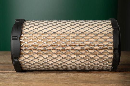 New air filter cartridge for a diesel lawn mower tractor engine, close-up.