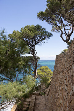 Cami de Ronda walking trail in Costa Brava, Spain on a sunny day with turquoise ocean