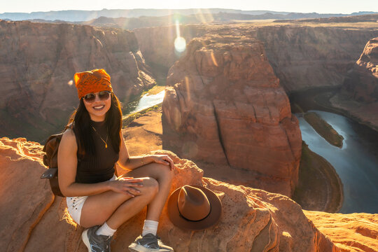 Woman enjoying breathtaking horseshoe bend view during sunset