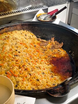 Preparing Traditional Plov in a Large Cauldron