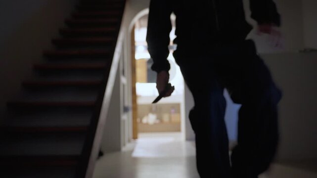 Killer holding knife enters dark house