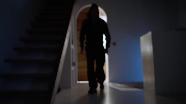 Hooded killer with knife sneaking into house at night