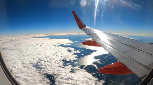 Airplane wing view from window emphasizing sustainability and breathtaking natural wonder