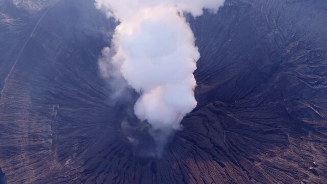 Aerial View of Mount Bromo Volcano Emitting Smoke and Steam into the Sky at Sunrise