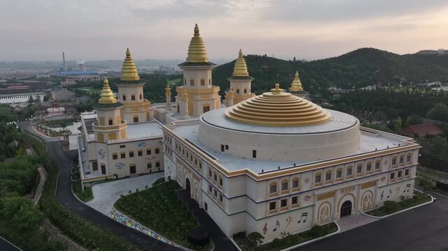 Chishan Fahua Temple complex with golden pagodas and domes in Weihai Shandong at sunset