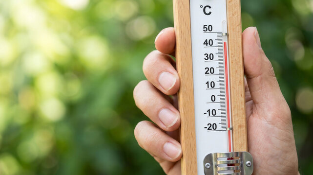Hand thermometer temperature high weather heat summer outdoor nature heat wave shows high temperature thermometer weather. Etreme global warming. sun hot warm heat stroke, red degree scale measure