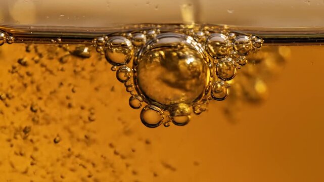 Bubbles in golden liquid symbolizing the limitless potential of digital design