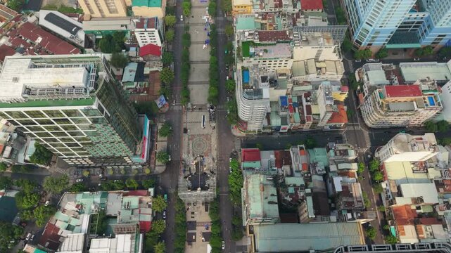 Vietnam, Ho Chi Minh Busy Street With Towering Buildings. Aerial Shot Of Vibrant Urban Pathway. High Vantage Point Captures Bustling Pedestrian Corridor Lined With Lush Foliage And Towering