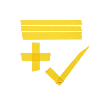 Yellow gaffer tape strips arranged into geometric symbols like crosses and checkmarks on a stark white surface representing a concept of organized decision making