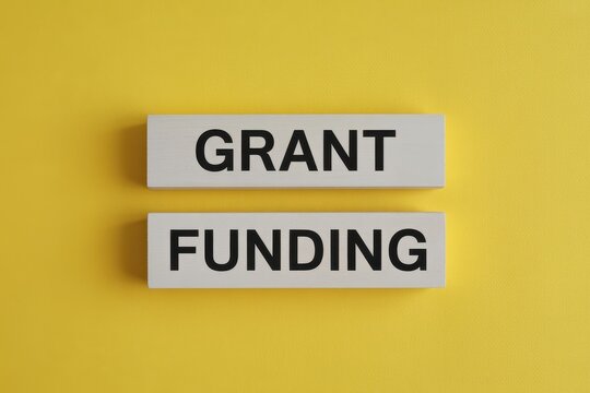 Grant Funding Concept on Yellow Background