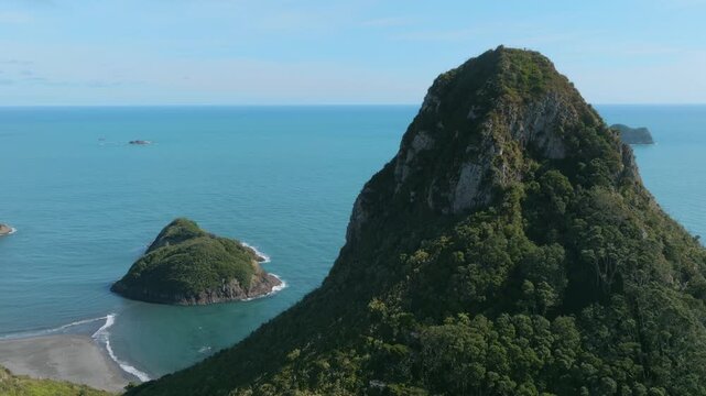 Aerial view of the coastal city of New Plymouth, New Zealand, showcasing the urban landscape, coastline, and the iconic Paritutu Rock.