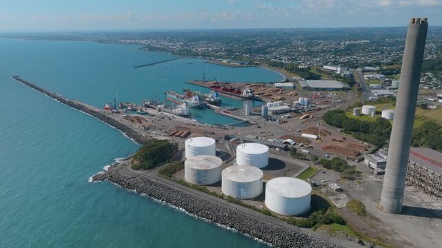 Aerial view of the Port of Taranaki, New Plymouth, New Zealand. Ships are docked, and the port is active with industry and commerce. The port facilitates trade and transportation.