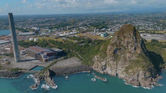 Aerial view of the Port of Taranaki, New Plymouth, New Zealand. Ships are docked, and the port is active with industry and commerce. The port facilitates trade and transportation.