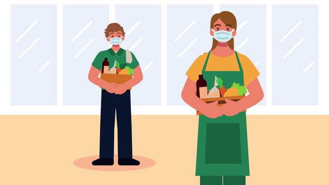 Grocery store workers wearing medical face masks while holding wooden crates with fresh vegetables.