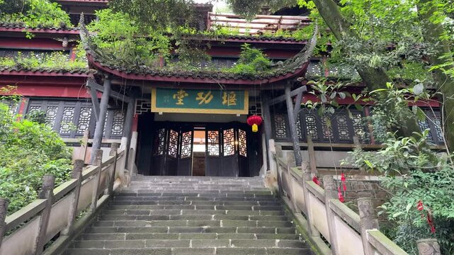 Chengdu, Sichuan/China - May 13 2026: A static view of stone steps leading to the historic Yan Gong Tang nestled in lush green trees at Dujiangyan.