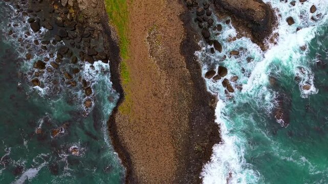 Top-down 4K 60FPS aerial video of The Giant's Causeway in Bushmills, County Antrim in Northern Ireland, UK. Produced in 3840x2160 and with Rec709 color. The sea and basalt colums are shown.