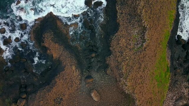 Reversing overhead 4K 60FPS aerial video of The Giant's Causeway in Bushmills, County Antrim in Northern Ireland, UK. Produced in 3840x2160 and with Rec709 color.