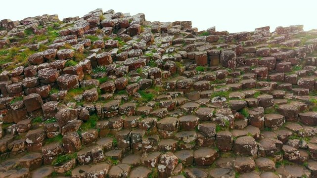 4K 60FPS aerial video of The Giant's Causeway in Bushmills, County Antrim in Northern Ireland, UK. Produced in 3840x2160 and with Rec709 color. The camera moves towards the balsalt columns.