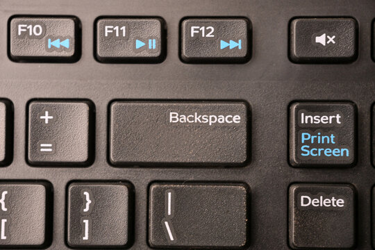 Black Computer Keyboard Macro Shot Highlighting Backspace Key with Soft Blurred Background Top View