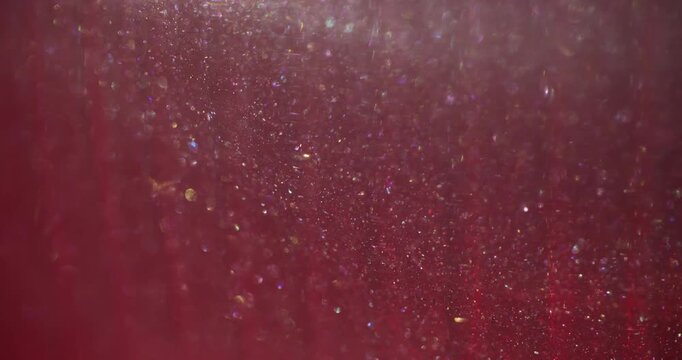 Blur sparkle. Light glitter dots. Red pink stream blend glowing rainbow powder. Art color bokeh luminosity abstract glossy background.