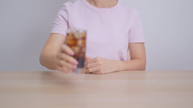Woman hand stop and refuse gesture to carbonated soft drink, feeling Abdominal pain after drinking soda water, bloating and gas in digestive system, stomach ache, Acid reflux, Heartburn and Gastritis
