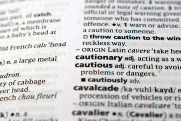 Fototapeta premium Close Up English Dictionary Page With The Word Translation Of - cautionary