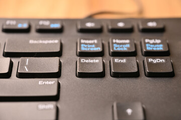 Obraz premium Black Computer Keyboard Macro Shot Highlighting Delete Key with Angled Top View and Soft Blurred Background