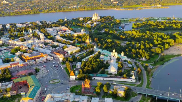 Yaroslavl, Russia. Spaso-Preobrazhensky Monastery, white fortress walls and golden domes catching the last rays of sunset, aerial panoramic view over the Kotorosl River. Drone footage