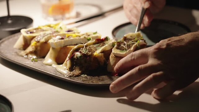 4K footage of a woman drinking red wine while a man enjoys an elegant appetizer at a fancy dining table, capturing upscale restaurant lifestyle and fine dining atmosphere.