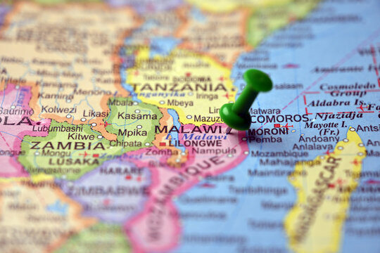 Green Push Pin Marking Malawi on Paper World Map Macro Shot with Soft Blurred Background