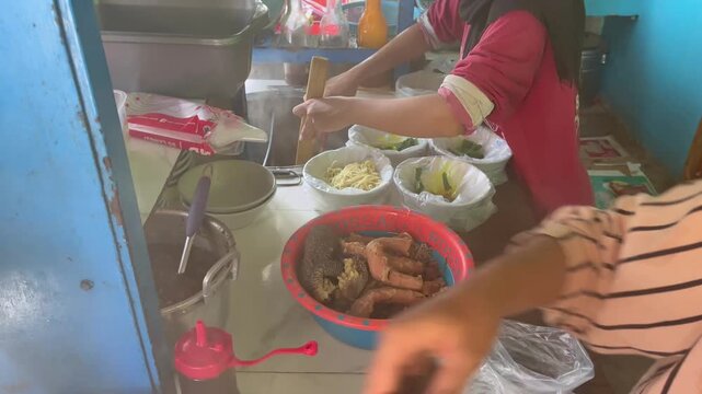 Street food vendor preparing traditional Indonesian chicken noodles