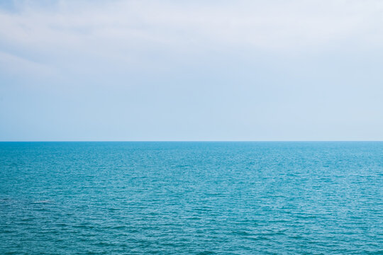 Beautiful seascape with blue sky on a sunny day. Nature background. Sea surface in sun light. Relaxing natural photo wallpaper.