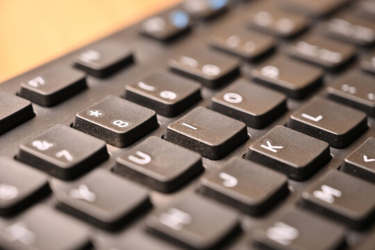 Black Computer Keyboard Macro Shot Highlighting I Key with Soft Blurred Background Angled Top View