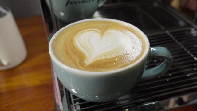 Barista Closeup Orbit of Heart Latte Art in Ceramic Coffee Cup drink details