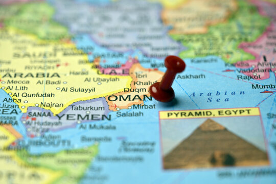 Red Push Pin Highlighting Oman on Paper World Map Macro Photography with Soft Blur
