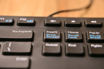 Obraz premium Modern Minimal Keyboard Macro Shot Featuring Insert and Print Screen Keys in Cinematic Soft Focus Angled Top View
