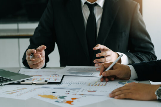 Teamwork with business people analysis cost graph on desk at meeting room.
