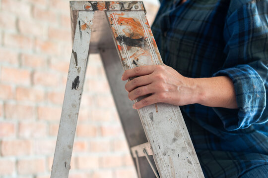 Person climbing old ladder safely.