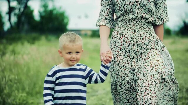 Mother and Toddler Walking Together in Summer Meadow. Family Bonding during Outdoor Walk in Nature. Happy Childhood Moments