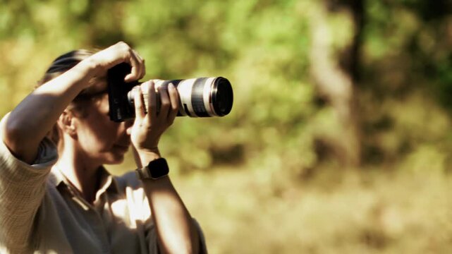 Photographer Capturing Nature and Wildlife with Digital Camera. Creative Specialist Working in Sunny Forest. Media Production