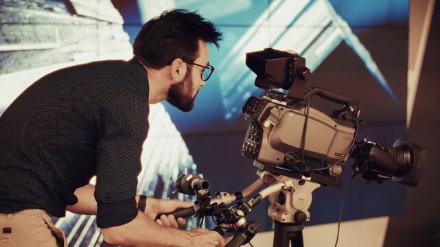 Cameraman Operating Digital Video Camera on Tripod. Filmmaker Working in Television Studio. Specialist Cinema Production  and Journalism