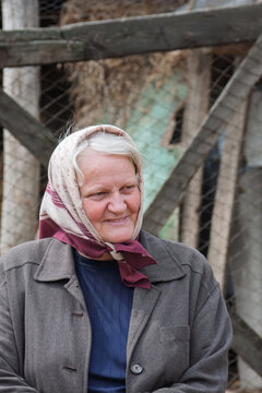Portrait of a Senior Eastern European Woman in Traditional Headscarf in Romania.