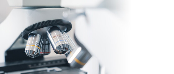 a close up view of a laboratory microscope with a white background and lab. © indraprojects