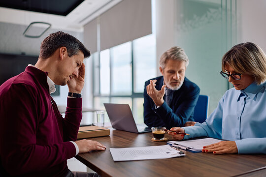 Job candidate feeling uncertain during recruitment interview in office.