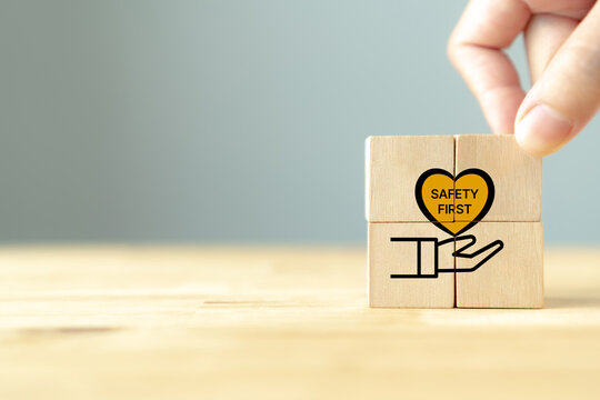 Safety first symbols, work safety, caution work hazards, danger surveillance, zero accident concept. Wooden cubes with smart grey background. Employees safety awareness at workplace. Safety banner.