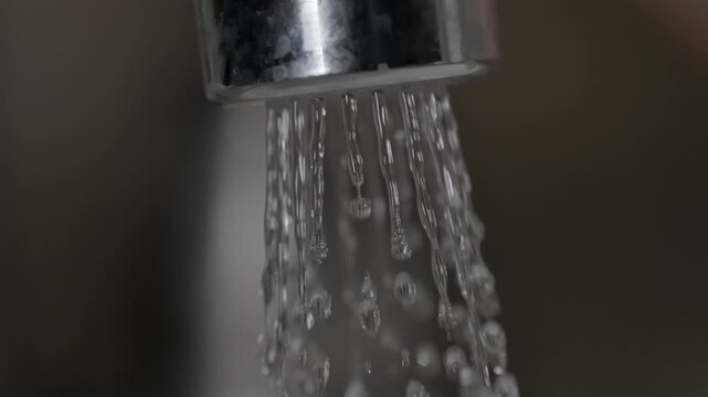 Water flowing from faucet above dirty drain, household plumbing task