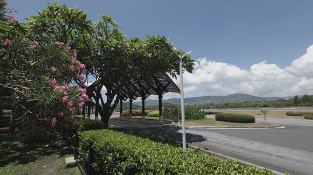 Gate at Samui airport, small buses driving by