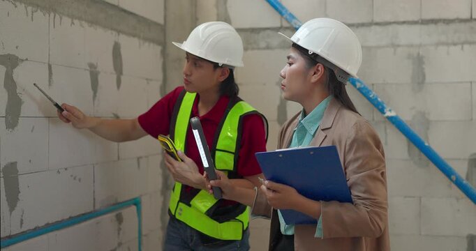Site Engineer and Interior Designer Measure Wall Alignment During Renovation