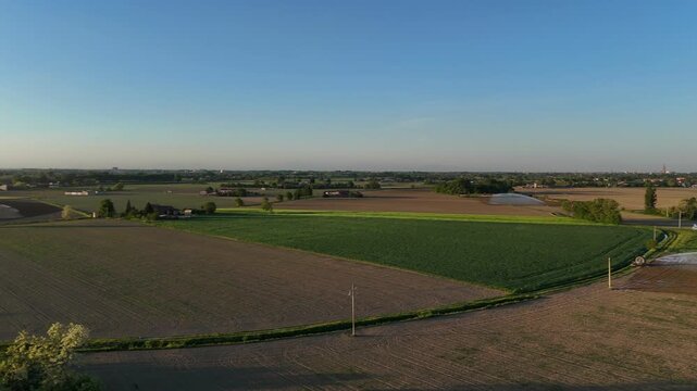 Golden hour sunset over Po Valley agricultural fields in springtime