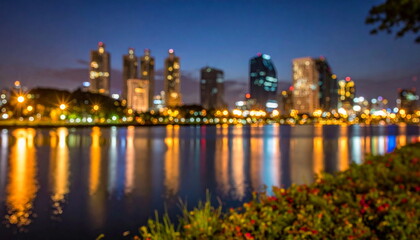 Obraz premium Blurred Cityscape Lights Reflecting on Lake Water at Night